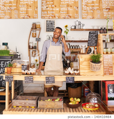 Thinking, smile and phone call with black man in coffee shop for communication, networking or service. Cafe, restaurant and small business with happy young store owner or vendor working in bakery Thinking, smile and phone call with black man in coffee shop for communication, networking or service. Cafe, restaurant and small business with happy young store owner or vendor working in bakery 140410464