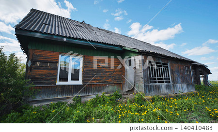 Old abandoned wooden house falling apart in slavic village 140410483