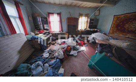 Abandoned messy room showing clutter, old furniture, dirt, and neglect in home 140410512