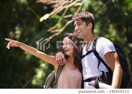 Couple, point and happy for hiking in jungle with smile for thinking, holiday and ideas on path. Man, woman and bag for trekking, direction and search in rainforest with guide at location in Colombia Couple, point and happy for hiking in jungle with smile for thinking, holiday and ideas on path. Man, woman and bag for trekking, direction and search in rainforest with guide at location in Colombia 140410513