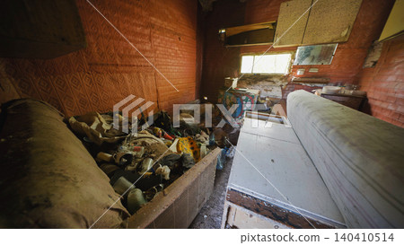 Abandoned slavic village house interior decaying with trash and furniture Abandoned slavic village house interior decaying with trash and furniture 140410514