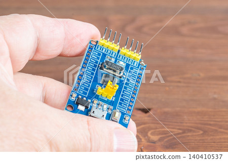 Development board STM and programmer in hand Development board STM and programmer in hand 140410537