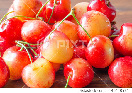 Ripe sweet cherries lie on a wooden background.. Close-up Ripe sweet cherries lie on a wooden background.. Close-up 140410585