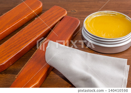 Applying beeswax to a wooden surface. Applying beeswax to a wooden surface. 140410598