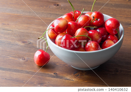 Ripe sweet cherries in a deep white bowl. Ripe sweet cherries in a deep white bowl. 140410632