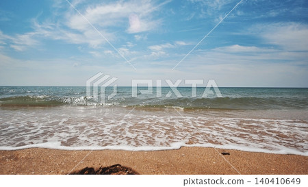 Gentle waves lapping sandy shoreline, blue sky with scattered clouds, peaceful crimean coastal landscape bathing in soft sunlight Gentle waves lapping sandy shoreline, blue sky with scattered clouds, peaceful crimean coastal landscape bathing in soft sunlight 140410649