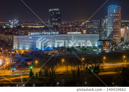 Minsk skyline at night featuring Hero City sign, modern urban buildings, and city lights Minsk skyline at night featuring Hero City sign, modern urban buildings, and city lights 140410662