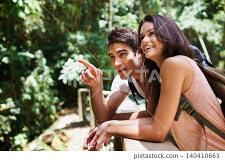 Hiking, talk or happy couple pointing in nature, forest or park on a trekking adventure on holiday. Man, woman or romantic people in woods for travel or journey for care, love or wellness on vacation Hiking, talk or happy couple pointing in nature, forest or park on a trekking adventure on holiday. Man, woman or romantic people in woods for travel or journey for care, love or wellness on vacation 140410663