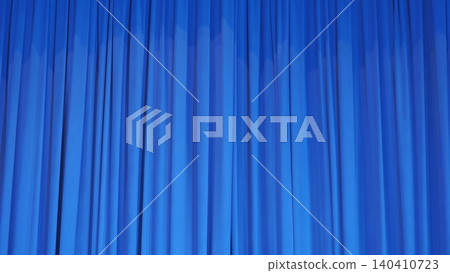 Vibrant blue stage curtain with soft vertical folds, theatrical background 140410723