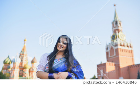 Bangladeshi woman in saree smiling in front of Saint Basil's Cathedral, Moscow 140410846