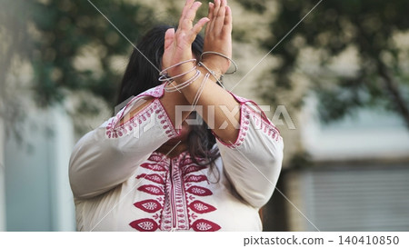 Indian woman celebrating Ganesh Chaturthi with traditional gestures and bangles Indian woman celebrating Ganesh Chaturthi with traditional gestures and bangles 140410850