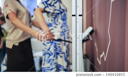 Dietitian measuring woman's height at nutrition clinic for health check-up 140410855