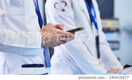 Medical professional using smartphone, connecting in a healthcare environment Medical professional using smartphone, connecting in a healthcare environment 140410877