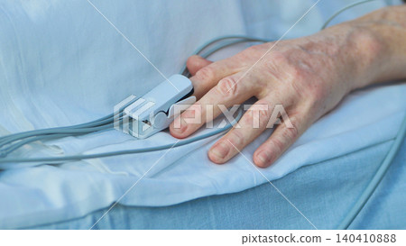 Senior patient hand with pulse oximeter monitoring vital signs in hospital Senior patient hand with pulse oximeter monitoring vital signs in hospital 140410888