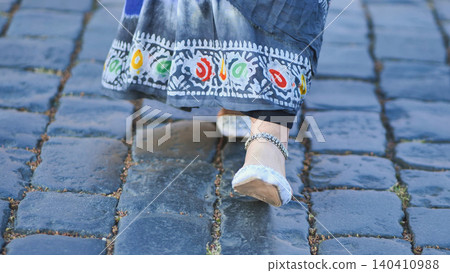 Bangladeshi woman wearing traditional dress and anklet walking on cobblestone street in Moscow 140410988