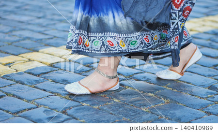 Bangladeshi woman wearing traditional saree and anklet walking on cobblestones in Moscow Bangladeshi woman wearing traditional saree and anklet walking on cobblestones in Moscow 140410989