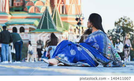 Indian woman sitting in traditional sari in Moscow Indian woman sitting in traditional sari in Moscow 140411007