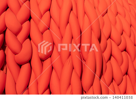 Abstract orange braided fabric creating a vibrant pattern and soft textile background Abstract orange braided fabric creating a vibrant pattern and soft textile background 140411038