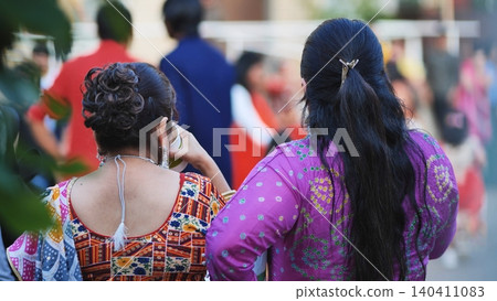 Indian women celebrating Ganesh Chaturthi festival wearing traditional clothing on street Indian women celebrating Ganesh Chaturthi festival wearing traditional clothing on street 140411083