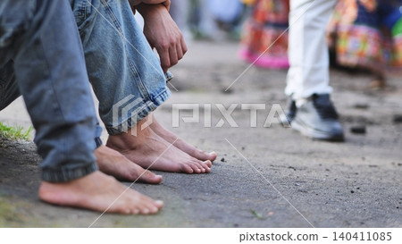 Barefoot devotees waiting for Ganesha festival celebration and procession in India Barefoot devotees waiting for Ganesha festival celebration and procession in India 140411085