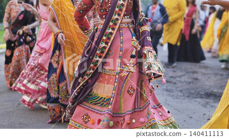 People celebrating Ganesh Chaturthi dancing in traditional Indian attire People celebrating Ganesh Chaturthi dancing in traditional Indian attire 140411113