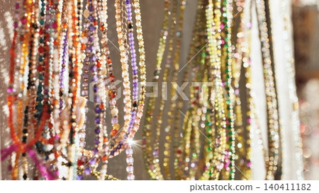 Indian market stall showcasing many colorful sparkling beaded necklaces and jewelry for sale Indian market stall showcasing many colorful sparkling beaded necklaces and jewelry for sale 140411182