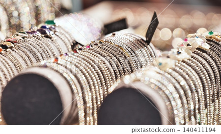 Stacks of sparkling ethnic bracelets and bangles on display at an Indian culture festival Stacks of sparkling ethnic bracelets and bangles on display at an Indian culture festival 140411194