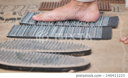 Sadhu standing on nail board practicing yoga in India Sadhu standing on nail board practicing yoga in India 140411225