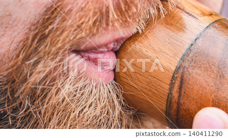 Close up of bearded man playing wooden flute at India Day festival in Moscow Close up of bearded man playing wooden flute at India Day festival in Moscow 140411290