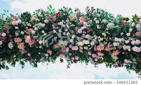 Beautiful flower arrangement hanging from ceiling creating stunning floral decoration 140411365