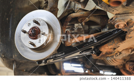 Car brake disc and suspension components in Moscow undergoing automotive service Car brake disc and suspension components in Moscow undergoing automotive service 140411388