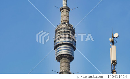 Ostankino Tower transmitting broadcasting signals over blue sky in Moscow 140411424