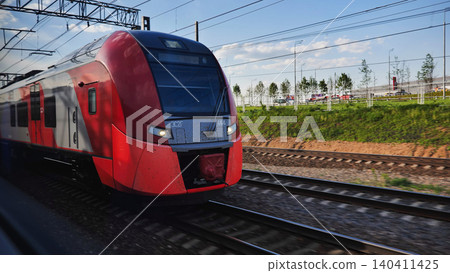 Lastochka train travelling fast on tracks in Moscow, modern transport system Lastochka train travelling fast on tracks in Moscow, modern transport system 140411425