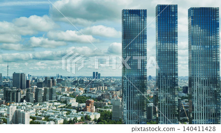 Three skyscrapers towering over Moscow cityscape under cloudy sky Three skyscrapers towering over Moscow cityscape under cloudy sky 140411428