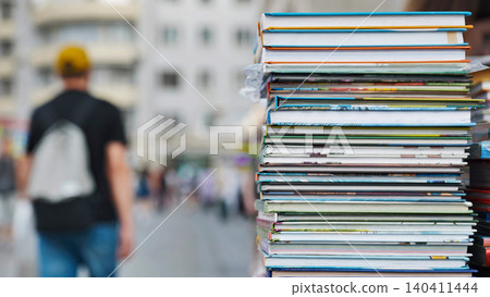 Stack of colorful books forming a tower in a city street market Stack of colorful books forming a tower in a city street market 140411444