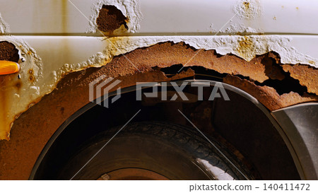 Deteriorating white car body showing severe rust and corrosion on wheel arch in Moscow Deteriorating white car body showing severe rust and corrosion on wheel arch in Moscow 140411472