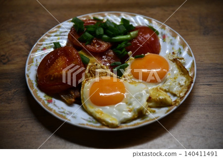 Fried eggs for delicious healthy easy breakfast on a table. Fresh homemade meal on a frying pan. Traditional breakfast food. International cuisine food. Fried eggs for delicious healthy easy breakfast on a table. Fresh homemade meal on a frying pan. Traditional breakfast food. International cuisine food. 140411491