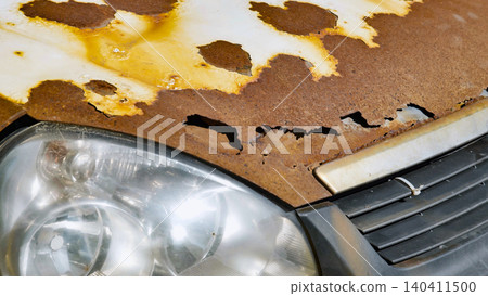 Abandoned car in Moscow showing severe rust and corrosion on hood and fender Abandoned car in Moscow showing severe rust and corrosion on hood and fender 140411500