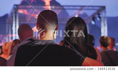 Couple enjoying live concert, watching performance at music festival with crowd 140411616