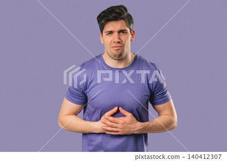 Man Experiencing Digestive Discomfort and Nausea After Meal. Food intolerance Man Experiencing Digestive Discomfort and Nausea After Meal. Food intolerance 140412307