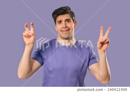 Skeptic young man With Hands Two Fingers Air Quotes On violet, Sarcasm,Cynicism Skeptic young man With Hands Two Fingers Air Quotes On violet, Sarcasm,Cynicism 140412309