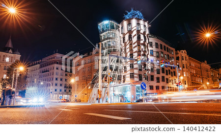 Night Traffic Near The Dancing House In Prague. City Moving Through Illuminated Night Traffic Near The Dancing House In Prague. City Moving Through Illuminated 140412422
