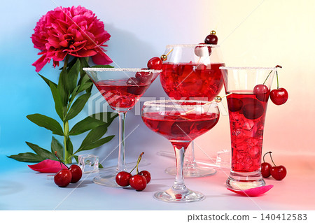 Cherry martinis, punch, sangria, and juice with ice for party.Modern still life with variety of summer alcoholic cocktails and peonies against sunny background.Minimalist concept for bar or cafe. 140412583