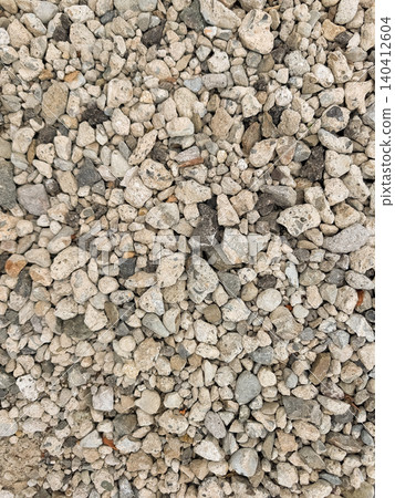 A gravel ground covered with crushed stones of various sizes / Construction materials and texture background material A gravel ground covered with crushed stones of various sizes / Construction materials and texture background material 140412604