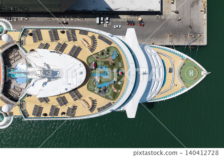 Aerial luxury liner voyage. Ship top view. Luxury liner resort. Cruise ship voyage. Entertainment sunbathing deck. Aerial top view of cruise in summer vacation. Cruise ship tour and travel at sea Aerial luxury liner voyage. Ship top view. Luxury liner resort. Cruise ship voyage. Entertainment sunbathing deck. Aerial top view of cruise in summer vacation. Cruise ship tour and travel at sea 140412728