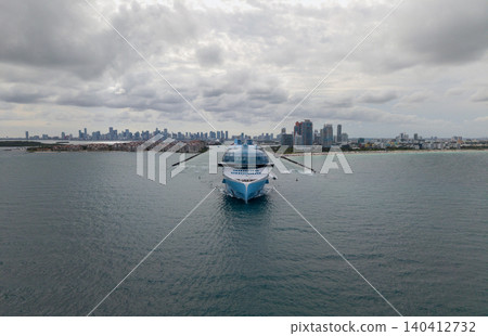 Aerial view cruise ship on summer vacation tour. Cruise ship vacation and travel by sea. Aerial view luxury liner. Ship leaving Miami beach port. Cruise ship vacation. Sail the sea Aerial view cruise ship on summer vacation tour. Cruise ship vacation and travel by sea. Aerial view luxury liner. Ship leaving Miami beach port. Cruise ship vacation. Sail the sea 140412732