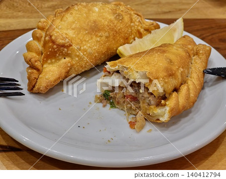 Traditional Argentine empanadas with beef, cheese and vegetable fillings Traditional Argentine empanadas with beef, cheese and vegetable fillings 140412794