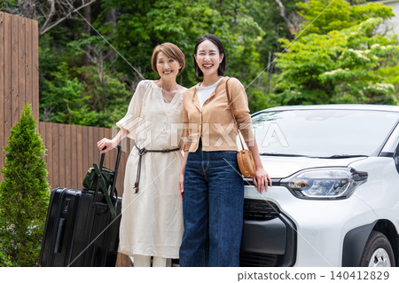 A smiling parent and child going on a road trip. A smiling parent and child going on a road trip. 140412829