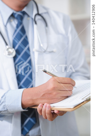 Medical professional documenting patient information in a clinical setting Medical professional documenting patient information in a clinical setting 140412906
