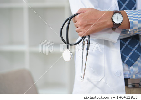 Medical professional holding stethoscope with a classic watch in healthcare setting Medical professional holding stethoscope with a classic watch in healthcare setting 140412915